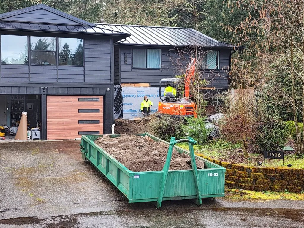 Rainier Dumpster Rental 10-yard rock box filled with dirt at a residential excavation site in Bellevue, WA.
